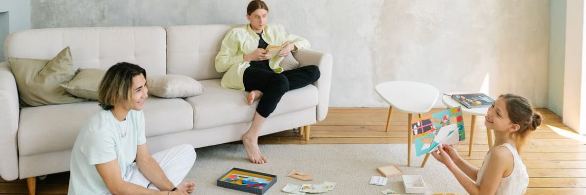 A family enjoying creative activities together in a bright living room setting.